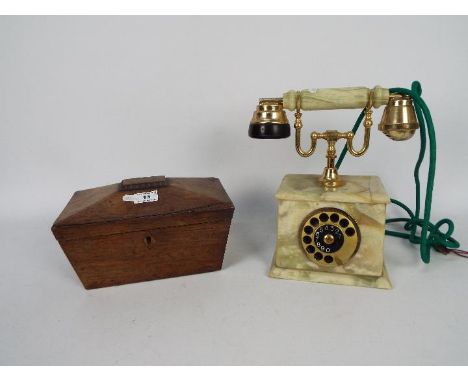 A twin compartment tea caddy of sarcophagus form, approximately 14 cm x 25 cm x 15 cm and a onyx cased telephone. [2]