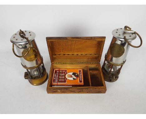 Two safety lamps, both Protector Lamp &amp; Lighting Co Type 6 and a carved wooden box. [3]