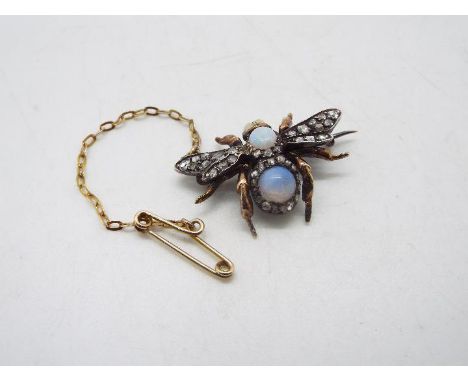 A diamond and opal set brooch in the form of a winged insect with cabochon opal to the torso and eyes with old cut diamonds s