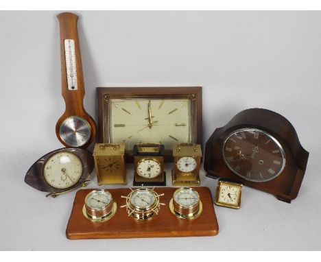 A collection of various clocks, barometer, weather station.