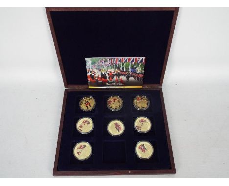A limited edition Royal Regiments commemorative coin collection comprising eight gold plated proof coins depicting British Ar
