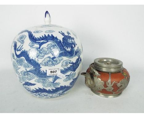 An ovoid blue and white jar and lid, decorated with dragon and flaming pearl, approximately 26 cm (h) and a Chinese teapot wi