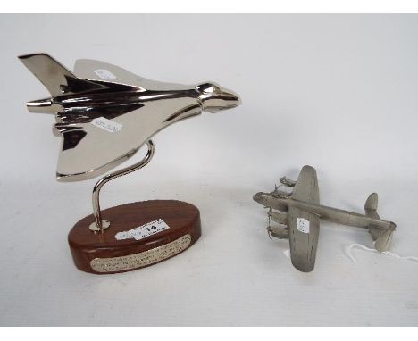 A chrome Vulcan Bomber desk ornament on wooden oval base (18 cm height) and a pewter Lancaster Bomber. [2]