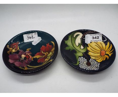 Moorcroft - Two Moorcroft Pottery coasters, the first a trial pattern of dandelion and one other, impressed and painted marks