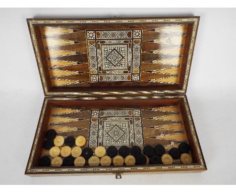 A Middle Eastern inlaid backgammon / chess set (no chess pieces included), 8.5 cm x 50 cm x 25 cm when closed.