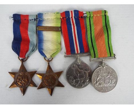 A World War Two (WW2 / WWII) group of four comprising British war Medal, Defence Medal, 1939 - 1945 Star and Atlantic Star wi