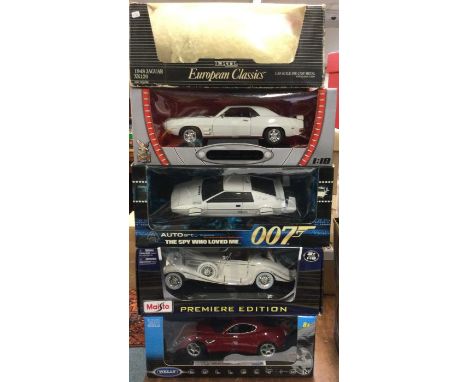 Five various 1:18 scale boxed model cars. Est. £20 - £30.