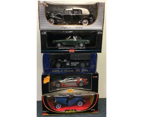 Five various 1:18 scale boxed model cars. Est. £20 - £30.