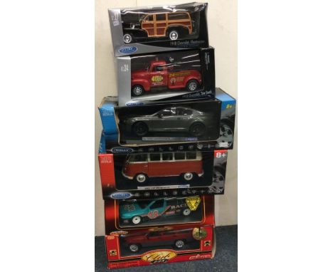 Four various 1:18 scale boxed model cars. Est. £20 - £30.