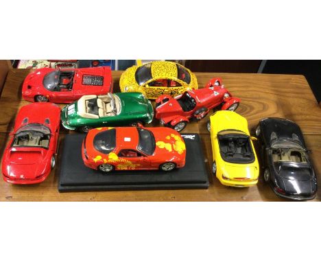 Eight various 1:18 scale unboxed model cars. Est. £20 - £30.