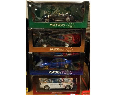 AUTO ART: Four various 1:18 scale boxed model cars. Est. £20 - £30.