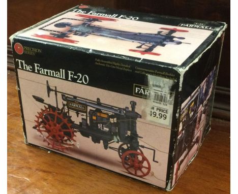 A boxed model of a Farmall tractor. Est. £20 - £30.