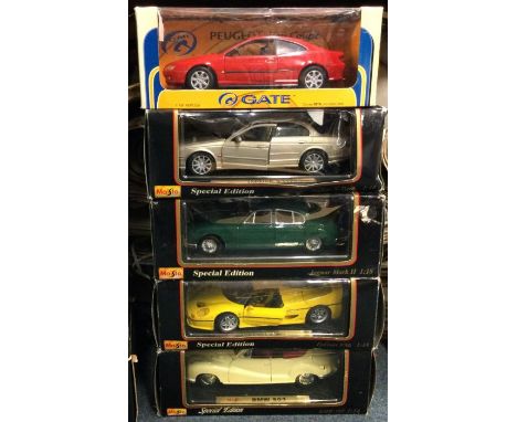 Five various 1:18 scale boxed model cars. Est. £20 - £30.