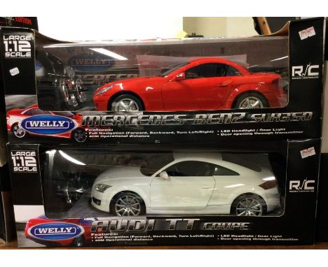 Two 1:12 scale boxed remote control cars. Est. £20 - £30.