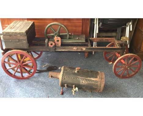 A large engine with vertical boiler complete with parts on trolley base. Est. £60 - £80.