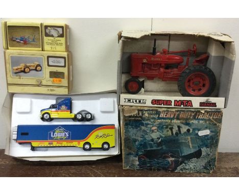 ERTL: A boxed tractor together with other items. Est. £20 - £30.