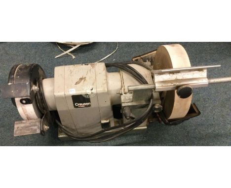An electric bench grinder. Est. £20 - £30.