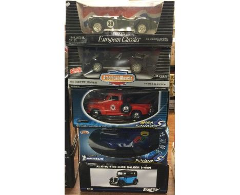 Five various 1:18 scale boxed model cars. Est. £20 - £30.