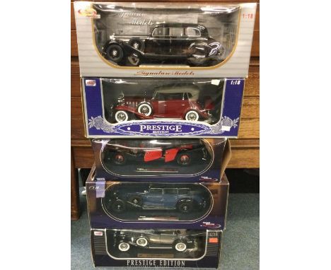 Five various 1:18 scale boxed model cars. Est. £20 - £30.