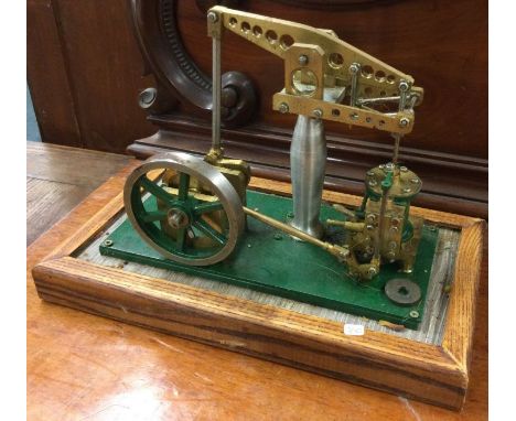 A cast iron and brass mounted stationary steam engine. Est. £20 - £30.