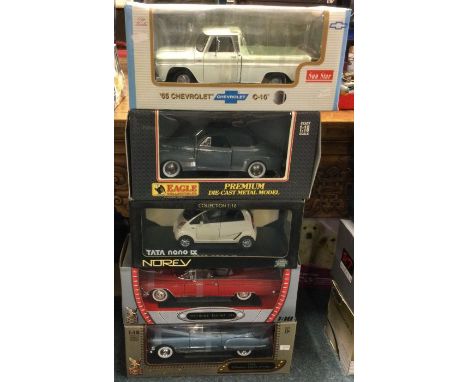 Five various 1:18 scale boxed model cars. Est. £20 - £30.