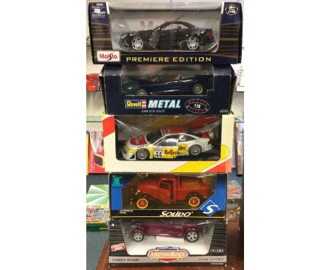 Five various 1:18 scale boxed model cars. Est. £20 - £30.