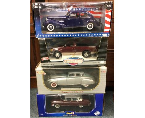 Four various boxed 1:18 scale model cars. Est. £20 - £30.