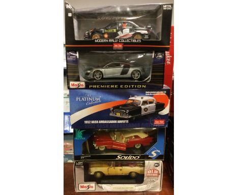 Five various 1:18 scale boxed model cars. Est. £20 - £30.