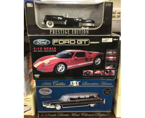 A Ford GT 1:12 scale boxed model car together with two other boxed cars. Est. £20 - £30.