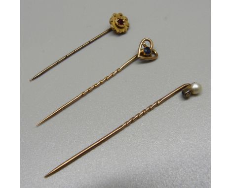 Three stick pins, two marked 9ct and one set with an old cut diamond and a pearl, total weight 3.2g 