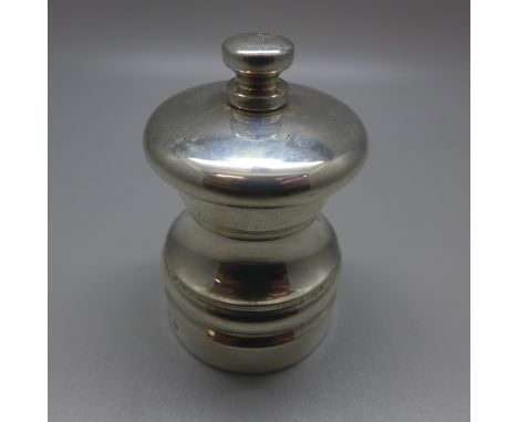 A silver pepper grinder 