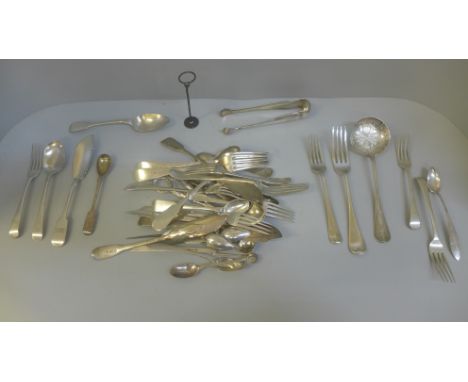 A collection of silver and white metal flatware, etc., 1,145g of hallmarked silver 