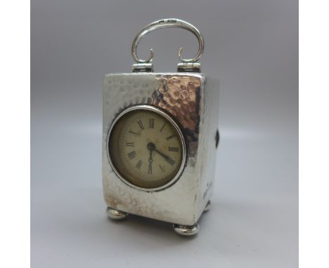 A silver cased Henry Matthews Arts and Crafts clock, Birmingham 1904, 63mm without handle 