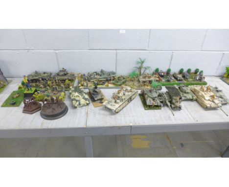 Seven plastic model dioramas of WWII soldiers and nine military vehicles 
