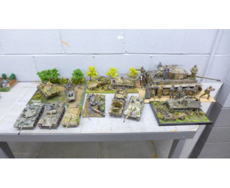 Four plastic model dioramas of WWII soldiers and five military vehicles 