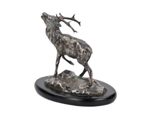  A small figurine of a deer made of silver and mounted on a black stone oval pedestal. Russia, St. Petersburg. Brothers Grach