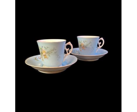 A pair of teacups and saucers from the Gardner factory. Bell-shaped handles with a rocaille curl and a saucer with a high sid