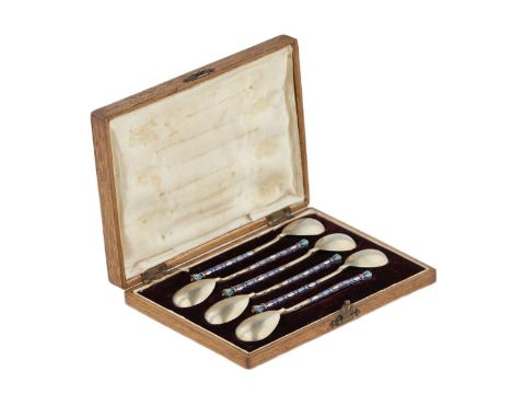 A set of teaspoons decorated with enamel in the original case. Six silver teaspoons decorated with opaque colored enamel (han