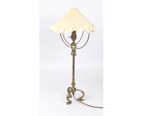 Arts & Crafts Brass table lamp with articulated top  on tripod foot base ending on spade feet 61.5cm high.