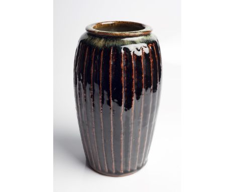 Mike Dodd (British, b.1943) Vase fluted sides and tenmoku glaze 25.5cm high.