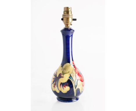 Moorcroft 'Hibiscus' lamp base on blue ground impressed manufacturer's stamp 22cm high.