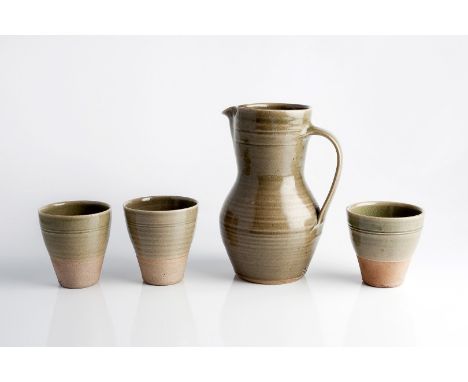 Leach Pottery Jug celadon glaze impressed St. Ives pottery seal 21cm high and three beakers (4).