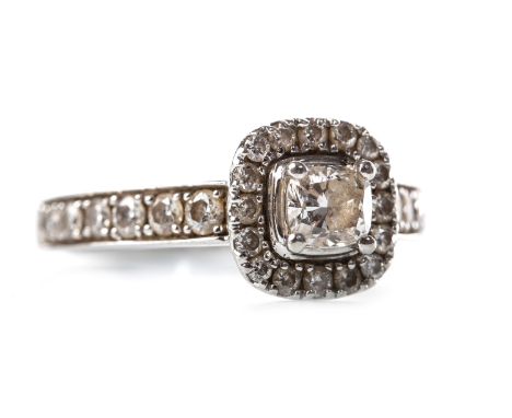 DIAMOND DRESS RING, the cushion shaped diamond within a round brilliant cut diamond halo, on diamond shoulders, the diamonds 