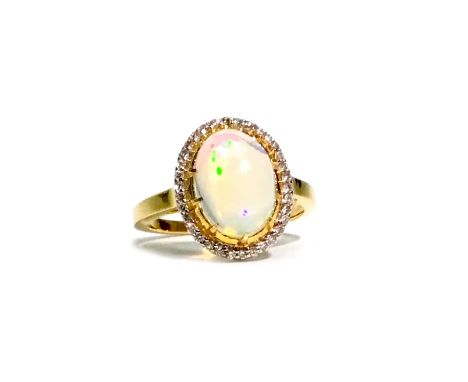 OPAL AND DIAMOND RING, the cabochon opal 11mm long and within a halo of round brilliant cut diamonds, the diamonds totalling 