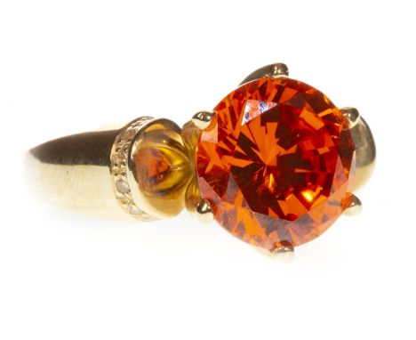 ORANGE GEM SET RING, set with a central round orange gem 10mm diameter, with round white gems set to the shoulders, marked 14