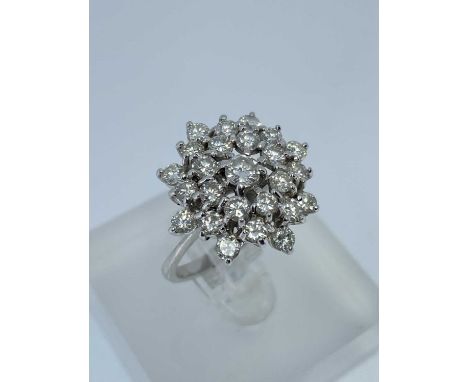 18CT WHITE GOLD DIAMOND CLUSTER RING, the central diamond (0.15cts approx.) surrounded by a further twenty-four diamonds, rin