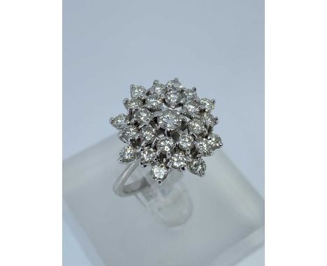 18CT WHITE GOLD DIAMOND CLUSTER RING, the central diamond (0.15cts approx.) surrounded by a further twenty-four diamonds, rin