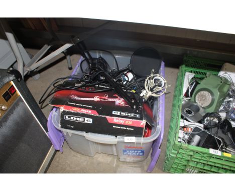 A box containing a microphone and various guitar leads