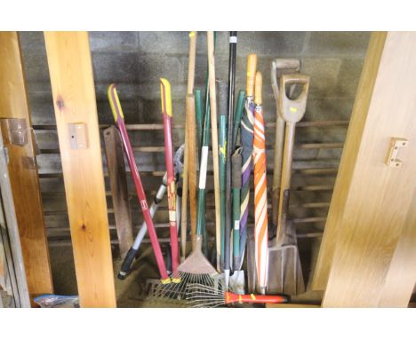 A quantity of various garden tools to include shovel, digging fork, rake, loppers, long handled trowel, umbrellas etc.
