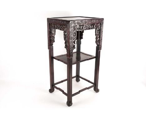 A late 19th century Chinese, two-tier hongmu pedestal, urn stand. With inset panel top and carved and pierced lotus motif thr